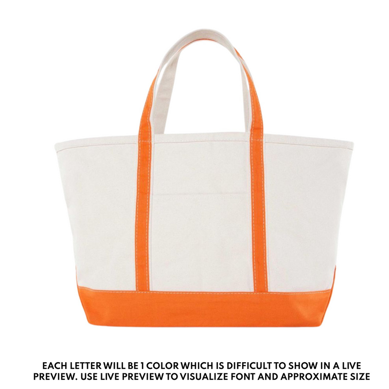Personalized canvas tote bag with bright orange handles and trim, custom embroidered for teachers.