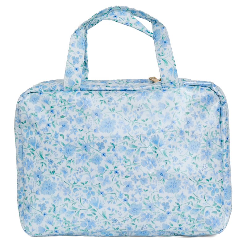A blue floral hanging toiletry bag with top carry handles