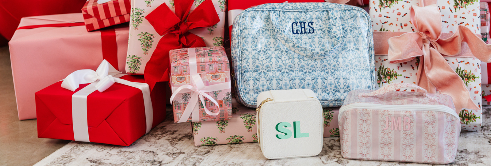 Festive holiday collection featuring monogrammed gifts under the Christmas tree.