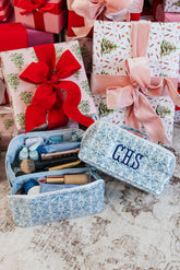 Holiday gift arrangement featuring embroidered pouch set.