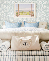 Personalized cream-colored weekender bag with black 'MYH' initials