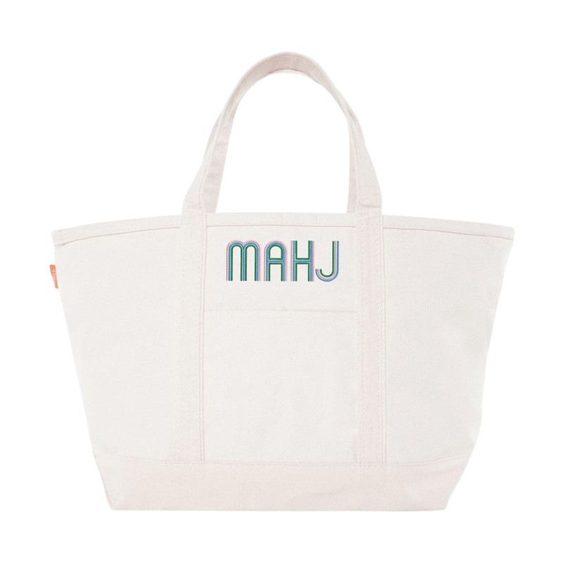 Cream canvas tote embroidered 'MAHJ' in a retro multicolor font, on a white background.
