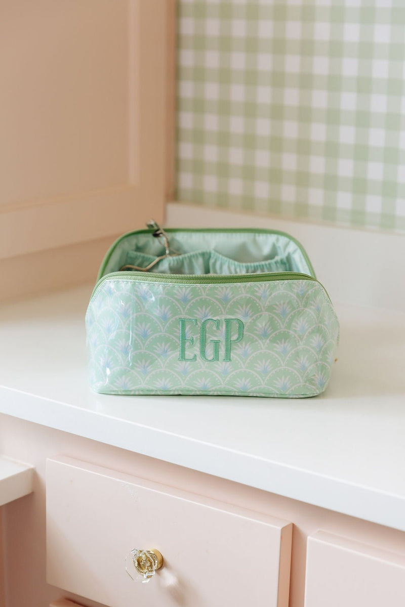 A green fan-print clear-coated pouch monogrammed 'EGP'