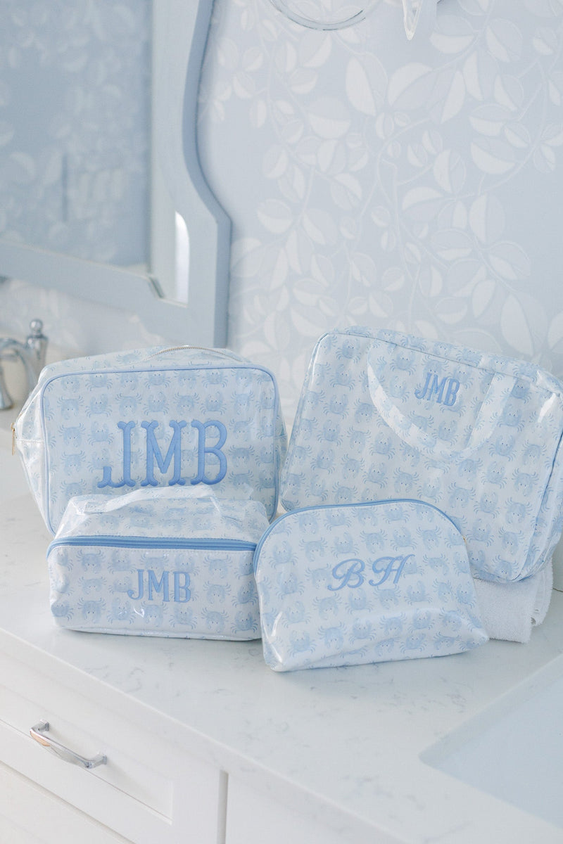Light blue crab print clear coated hanging toiletry bags monogrammed JMB and BH on a bathroom counter
