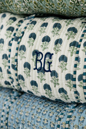 White embroidered block print duffel with navy floral pattern and custom initials embroidery.