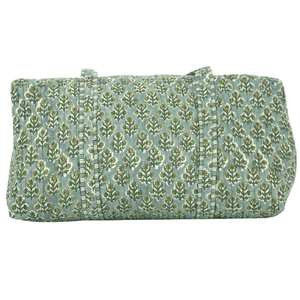 Close-up of green Embroidered Block Print Duffel bag with floral design and beige monogram, handmade travel accessory.