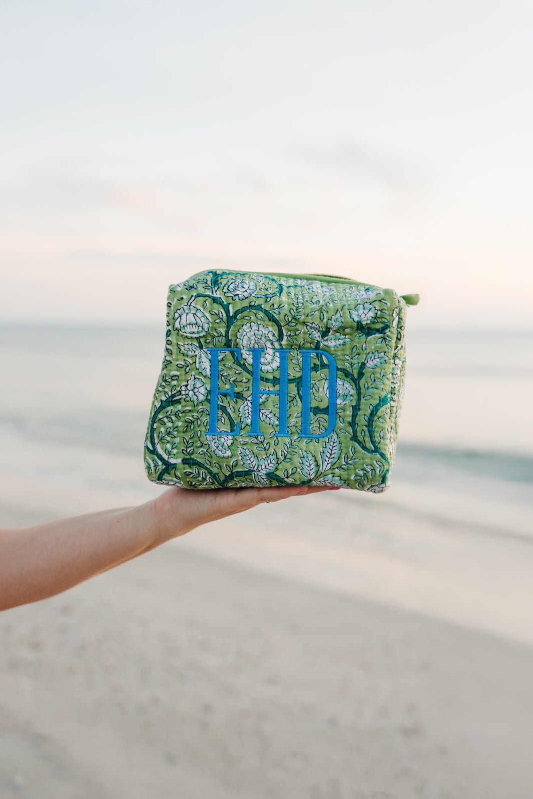Assorted Embroidered Block Print Pouches in vibrant green, pink, lavender, and blue floral patterns with personalized monograms—perfect for travel or everyday use.