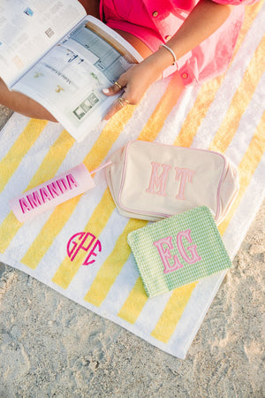 Embroidered cabana beach towel with personalized monogram.