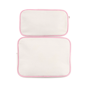 Large and extra-large canvas pouches with embroidered trim and monogram.