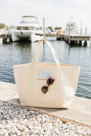 White embroidered tote with applique initials, chic and functional.