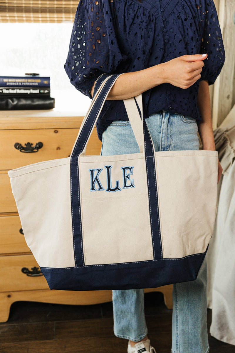 Navy embroidered tote with applique monogram, everyday functional style.