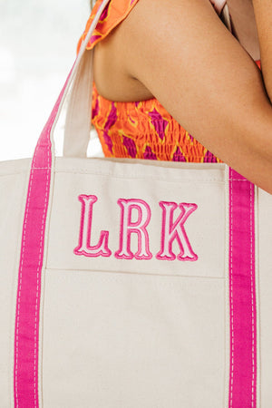 Embroidered canvas tote with pink applique initials, trendy personalized bag.