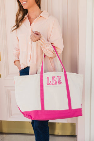 Monogrammed embroidered tote bag with pink applique design, great for gifting.