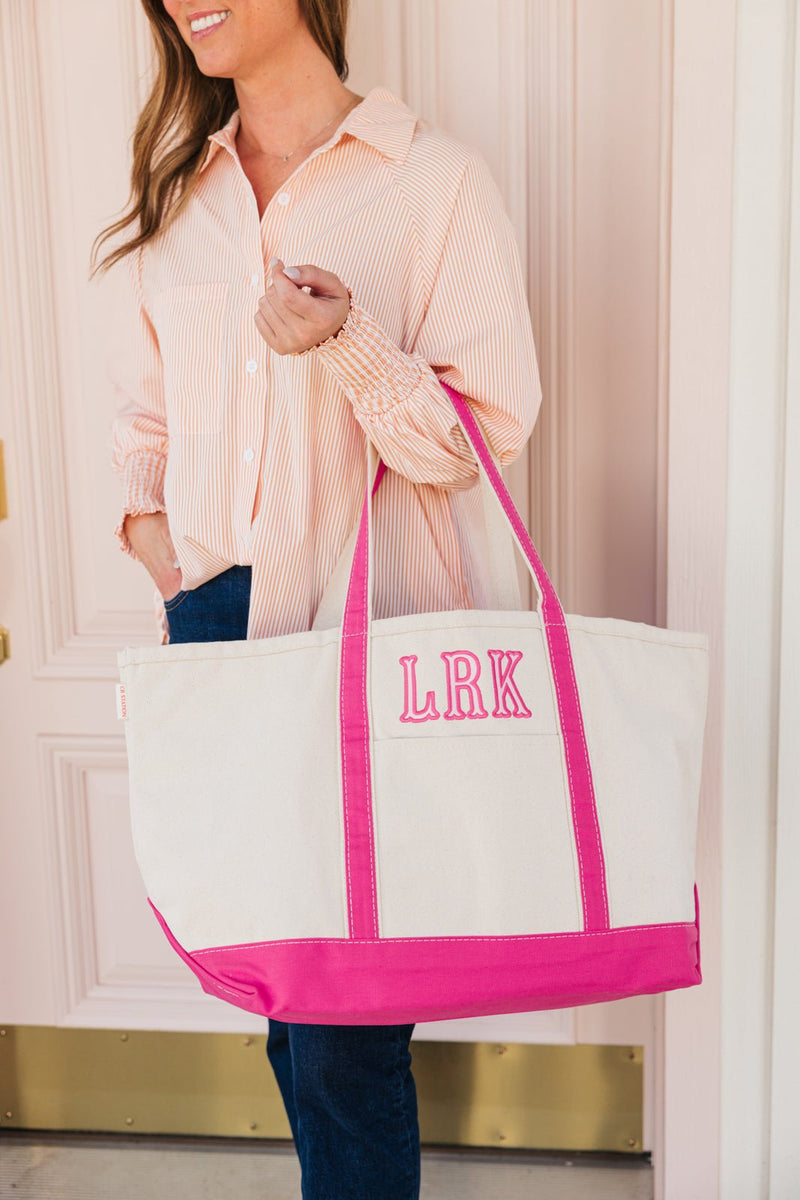Monogrammed embroidered tote bag with pink applique design, great for gifting.