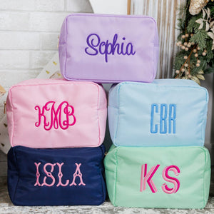 Five nylon pouches embroidered with the name 'Sophia' and monograms KMB, CBR, ISLA, and KS