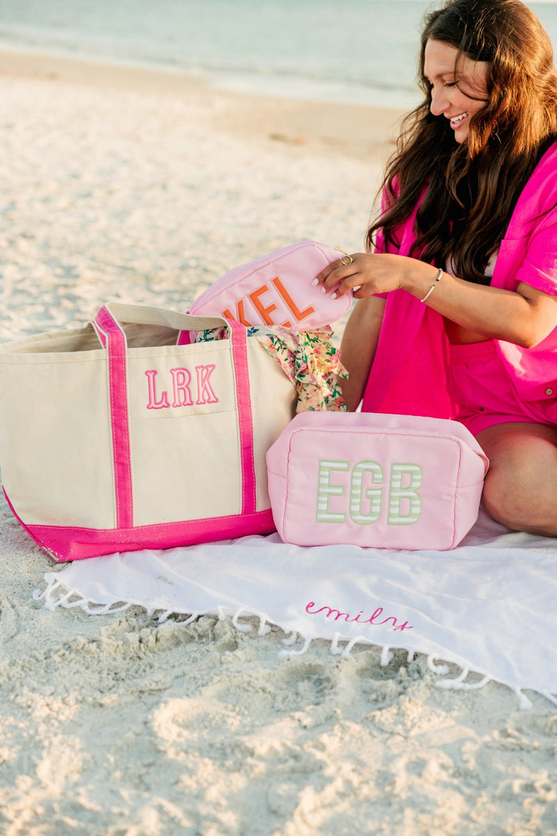 Large nylon pouch with applique monogram, perfect for organized travel storage.