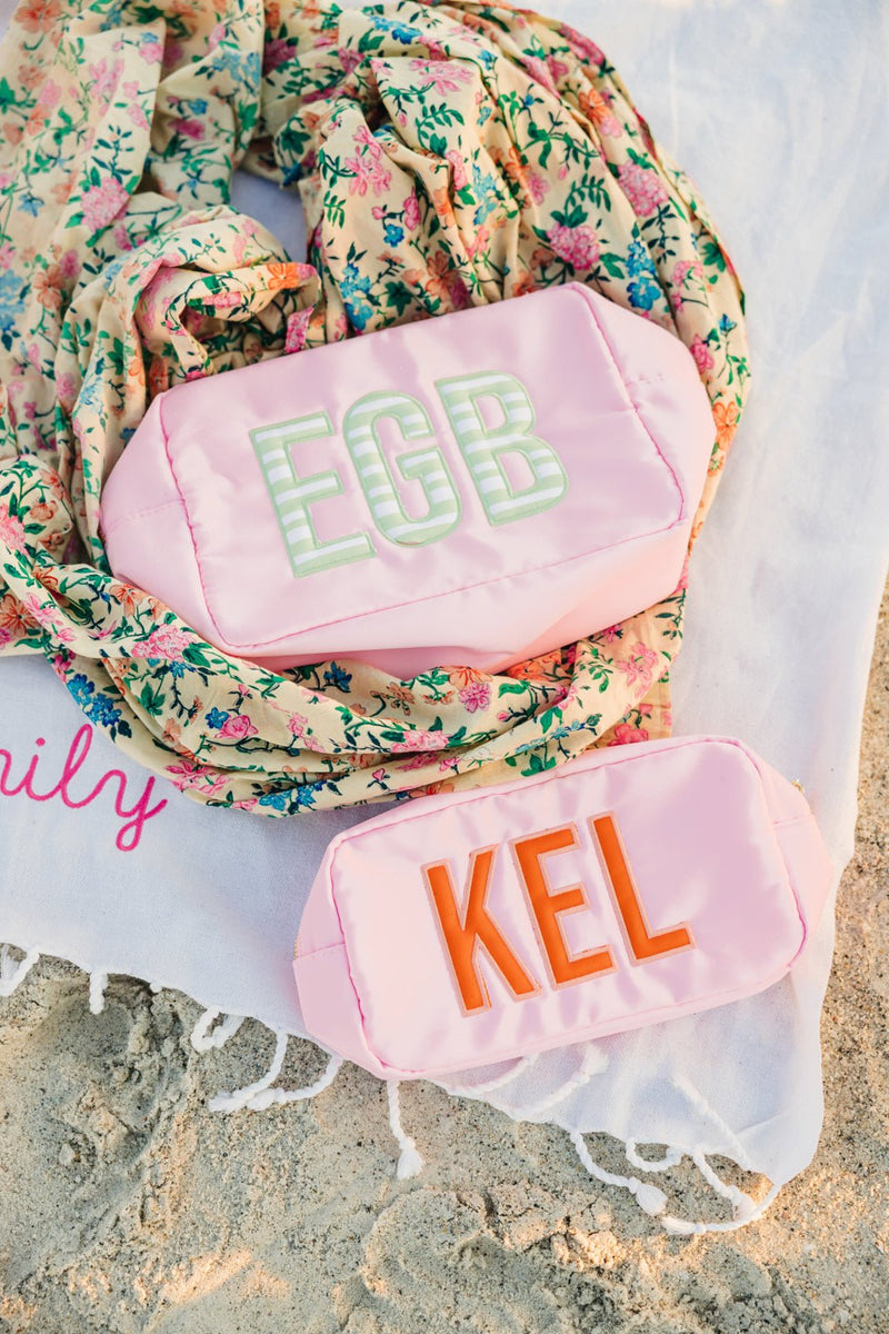 Pink embroidered extra-large nylon pouch with bold applique monogram EGB.
