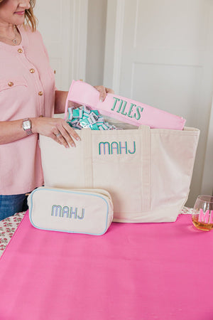 Custom embroidered large canvas pouch with applique letters styled with decor.