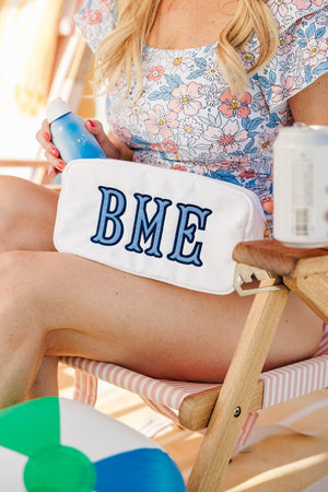 Embroidered large nylon pouch with bold applique letters BME in blue.
