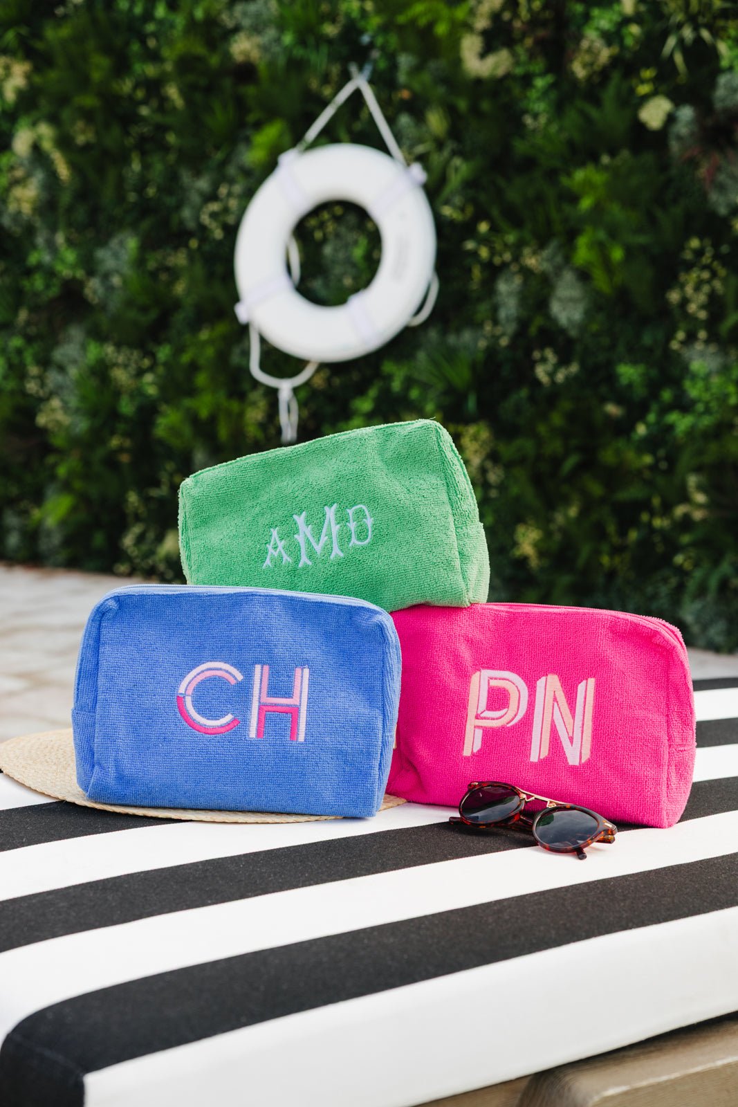 A set of Personalized Waffle Cosmetic Bags from Sprinkled with Pink, featuring one hot pink bag with a cursive embroidered name "Taylor" and one periwinkle blue bag with a shadow monogram "CH." These stylish and functional pouches are perfect for storing makeup, skincare, or travel essentials. Made from a soft waffle-textured fabric with a zippered closure, these cosmetic bags add a custom touch to any beauty routine or travel set. Ideal for gifting, bridesmaids, or everyday organization.