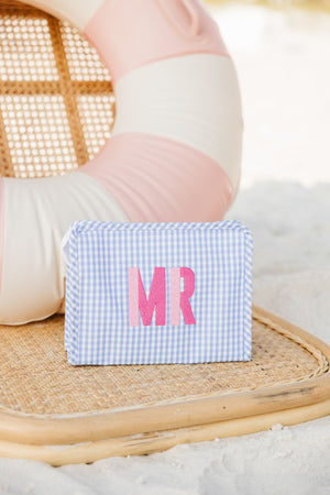 A lilac roadie is customized with a pink Duo monogram at the beach.