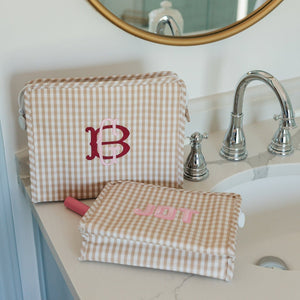 Embroidered travel roadie bag personalized with initials, styled with accessories for a chic on-the-go look.