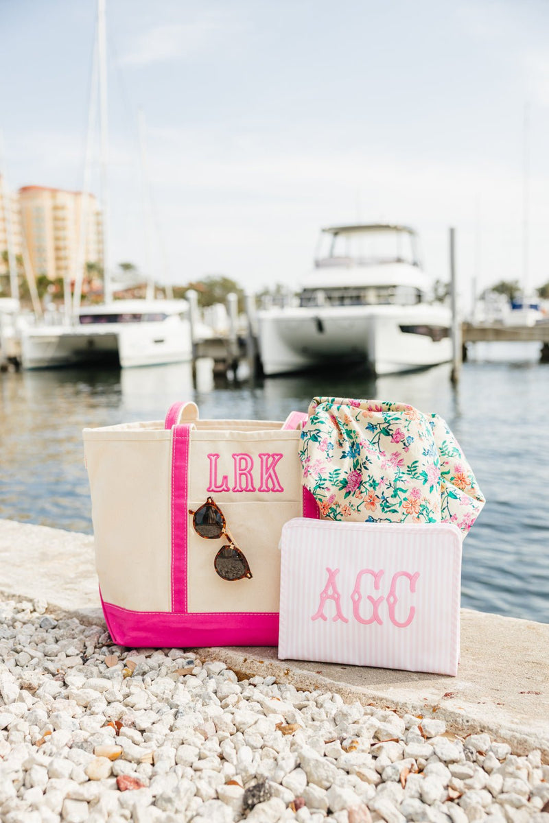 Personalized embroidered TRVL Roadie bag with colorful monogram design.