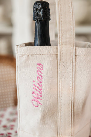 Canvas wine tote with custom embroidered name, elegant and eco-friendly wine gifting bag.