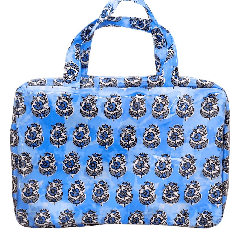 A blue block-print hanging toiletry bag with top carry handles