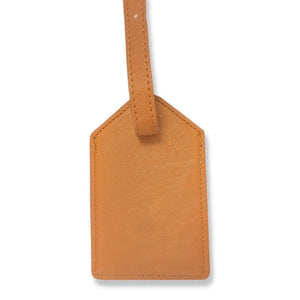 Tan leather luggage tag featuring a gold foil monogram, perfect for personalized travel and gifting.