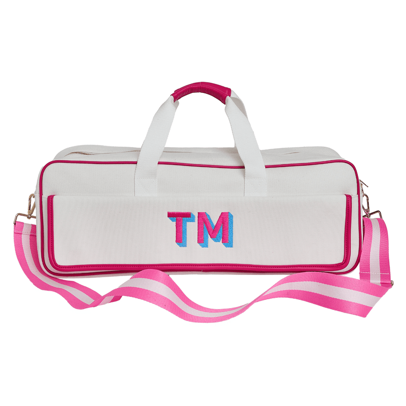 White canvas mahjong carryall duffel with pink trim monogrammed "TM" in blue and pink, with a matching pink and white striped strap