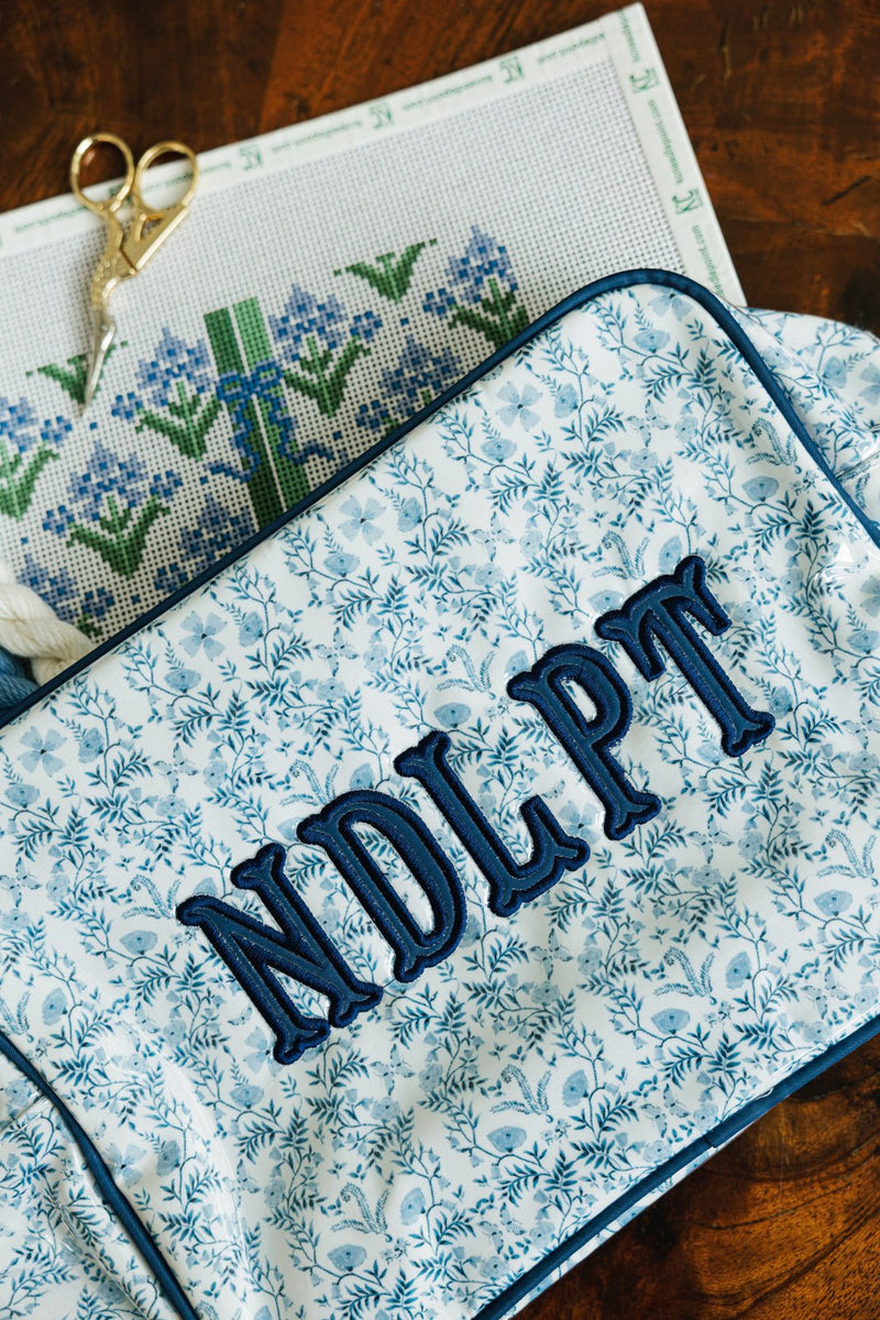 Blue floral Needlepoint XL Project Pouch with embroidered text, ideal for crafting and storage.