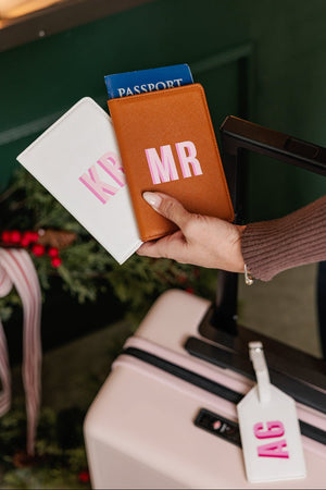 Custom leather passport holder with embroidered initials, perfect travel gift.