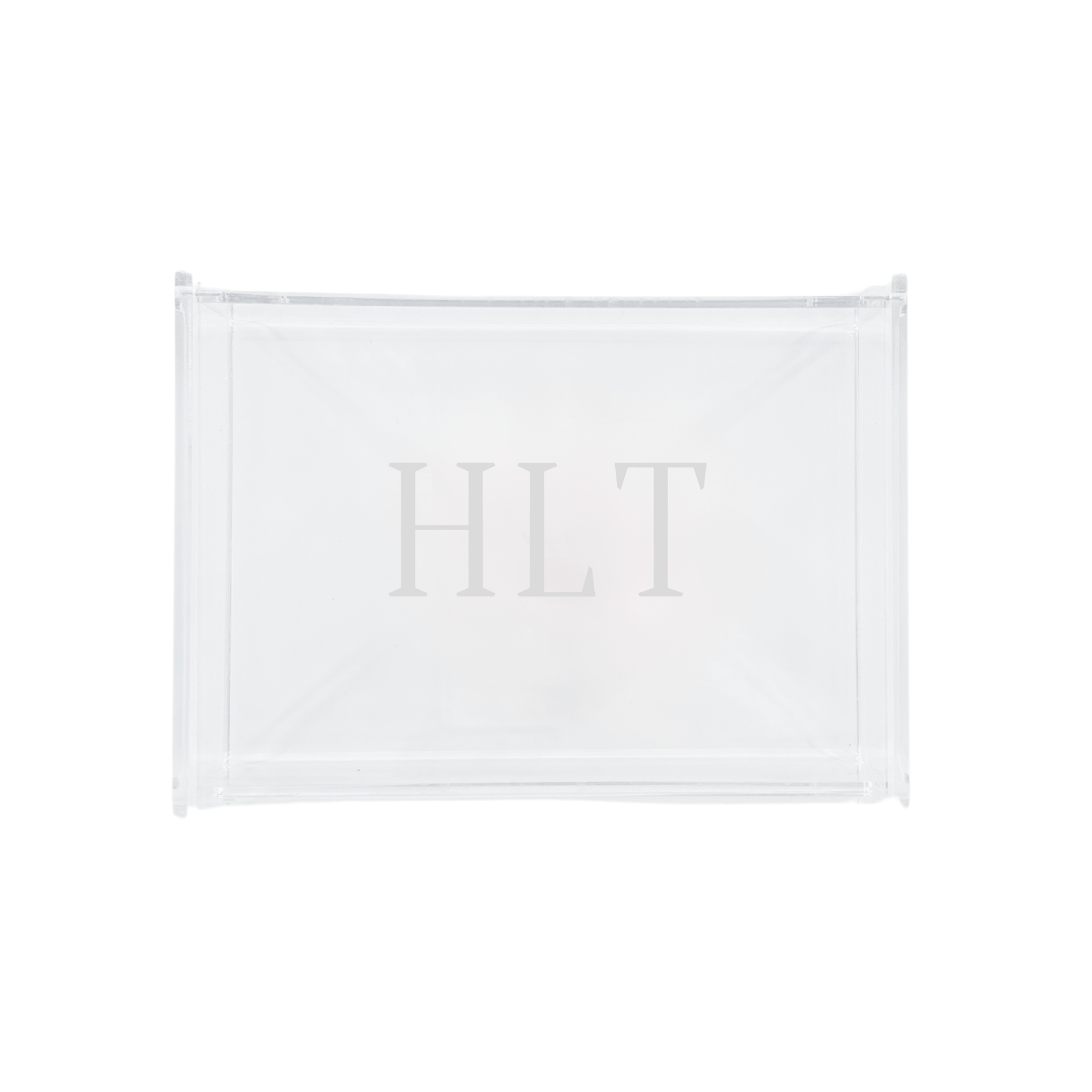 A sleek and modern personalized acrylic tray monogrammed with 'HLT,' perfect for stylish organization and display. This transparent, minimalist design seamlessly complements any home décor, making it an ideal gift or chic storage solution. Pair it with other customized accessories for a cohesive and elegant set.