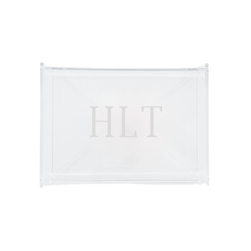 A sleek and modern personalized acrylic tray monogrammed with 'HLT,' perfect for stylish organization and display. This transparent, minimalist design seamlessly complements any home décor, making it an ideal gift or chic storage solution. Pair it with other customized accessories for a cohesive and elegant set.
