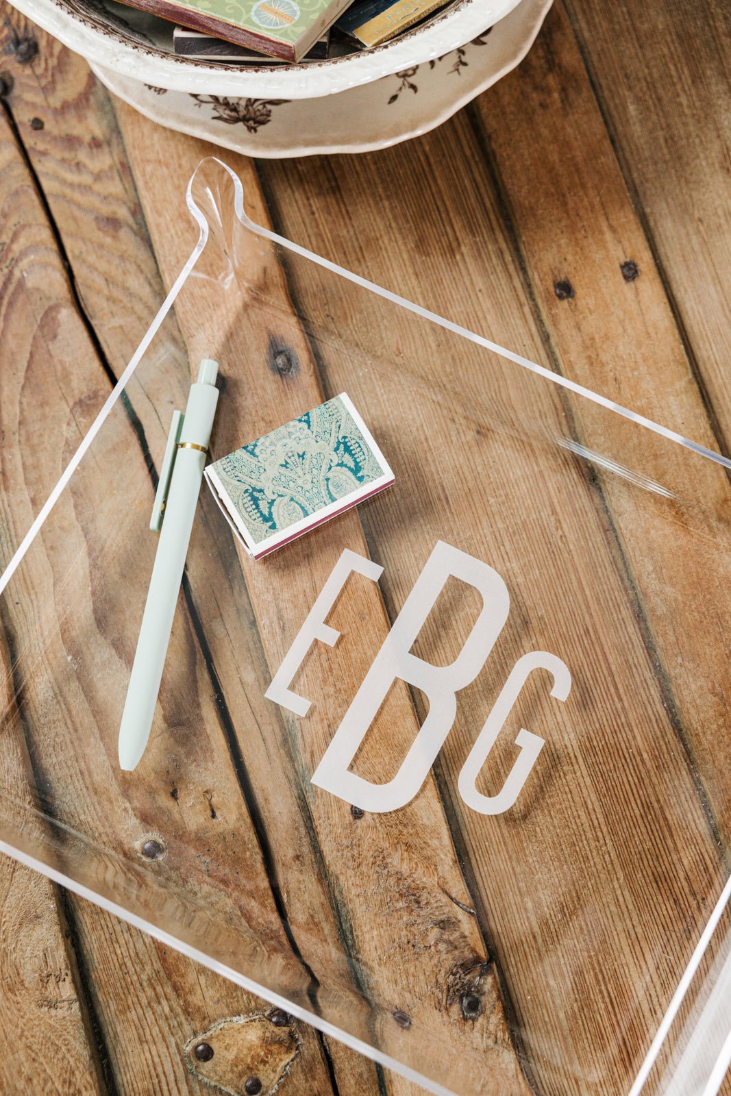 A set of two personalized acrylic trays featuring elegant monogrammed designs—one with the name 'WILLIAMS' and the other with initials 'EBG.' These chic and versatile catch-all trays add a stylish touch to any space, perfect for organizing small essentials on a desk, dresser, or entryway. Pair them with other custom acrylic accessories for a coordinated look