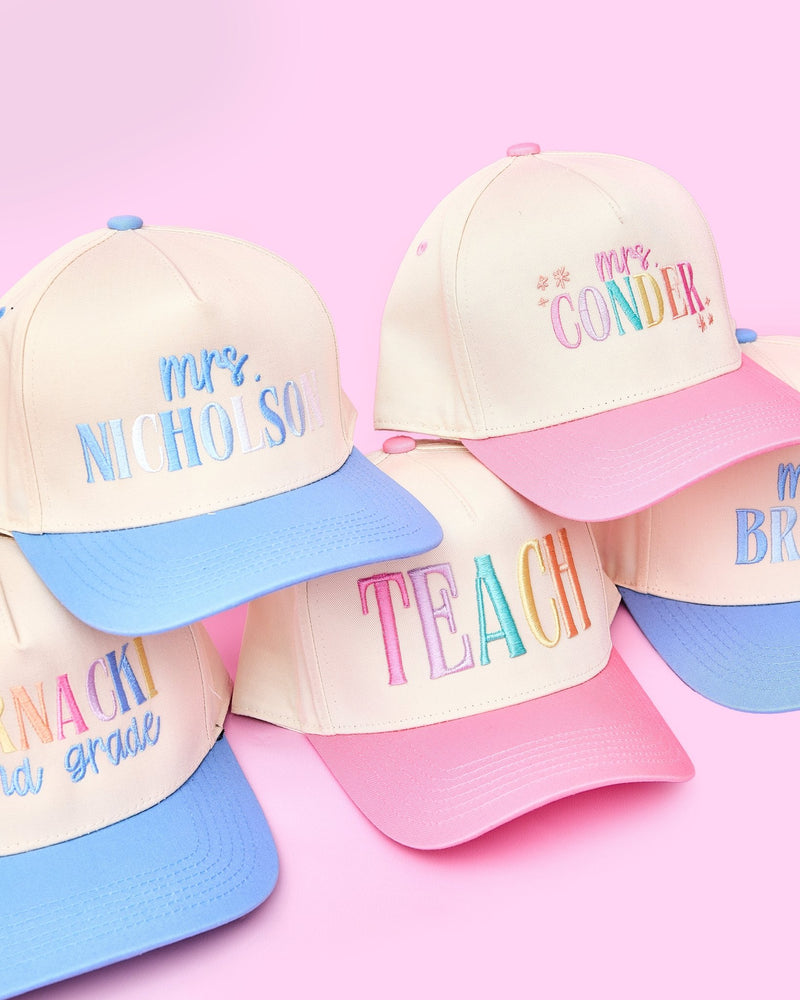 Teach 3D Puff Trucker Hats – @PBANDJ4THGRADE x SWP: cream front panels with pastel 3D puff “TEACH” embroidery and alternating pink and blue mesh brims