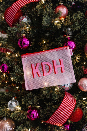 Pink embroidered pool bag under Christmas tree, personalized holiday gift.
