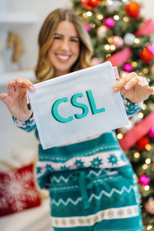 Woman holding teal monogrammed pool bag, personalized holiday gift.