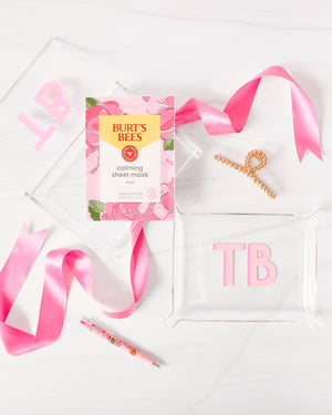 An acrylic box and a small acrylic tray are customized with matching monograms and gifted with a pink bow.