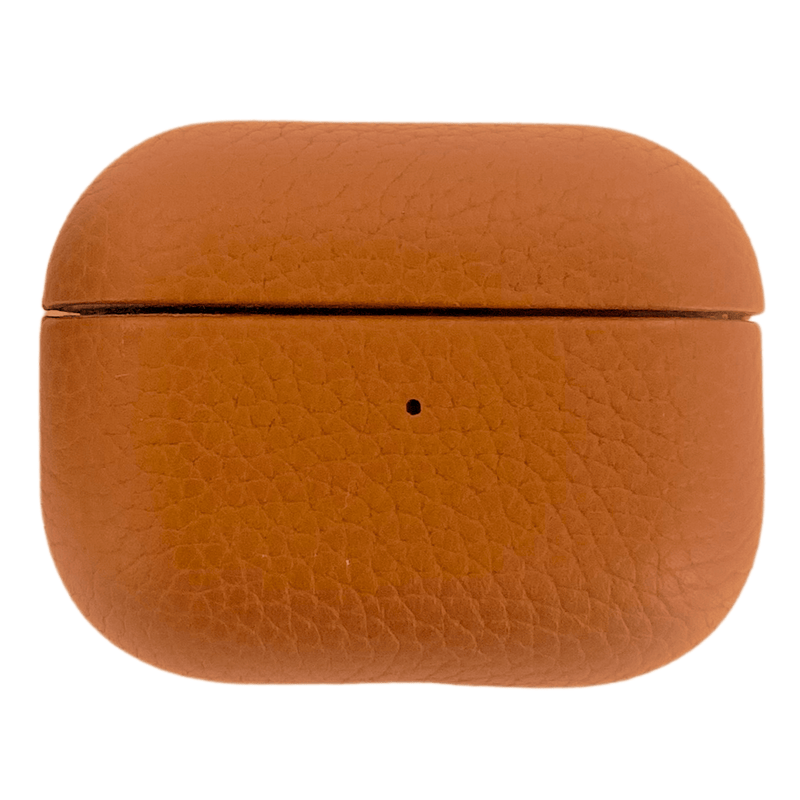 A sleek tan leather AirPods case with a minimalist design, part of a personalized monogrammed travel accessories set. This stylish and protective case complements a coordinated collection, perfect for keeping tech essentials secure while adding a sophisticated touch to everyday carry items.