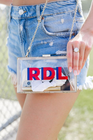 Clear stadium bag with gold chain strap and bold red-blue “RDL” shadow monogram – personalized and stadium-approved