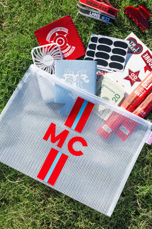 Red striped “MIC” clear mesh Striped Monogram Pool Bag held at the field, perfect for stadium or poolside basics.