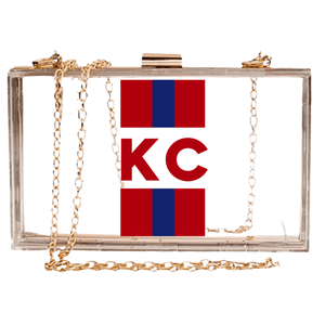 Clear stadium bag with purple stripes, bold “GB” monogram on front, and gold chain strap