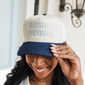 Woman wearing a personalized embroidered bucket hat, a fun and trendy summer accessory.