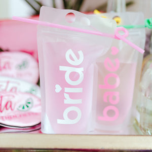 Party pouches customized to read "bride" and "babe" in our doll font