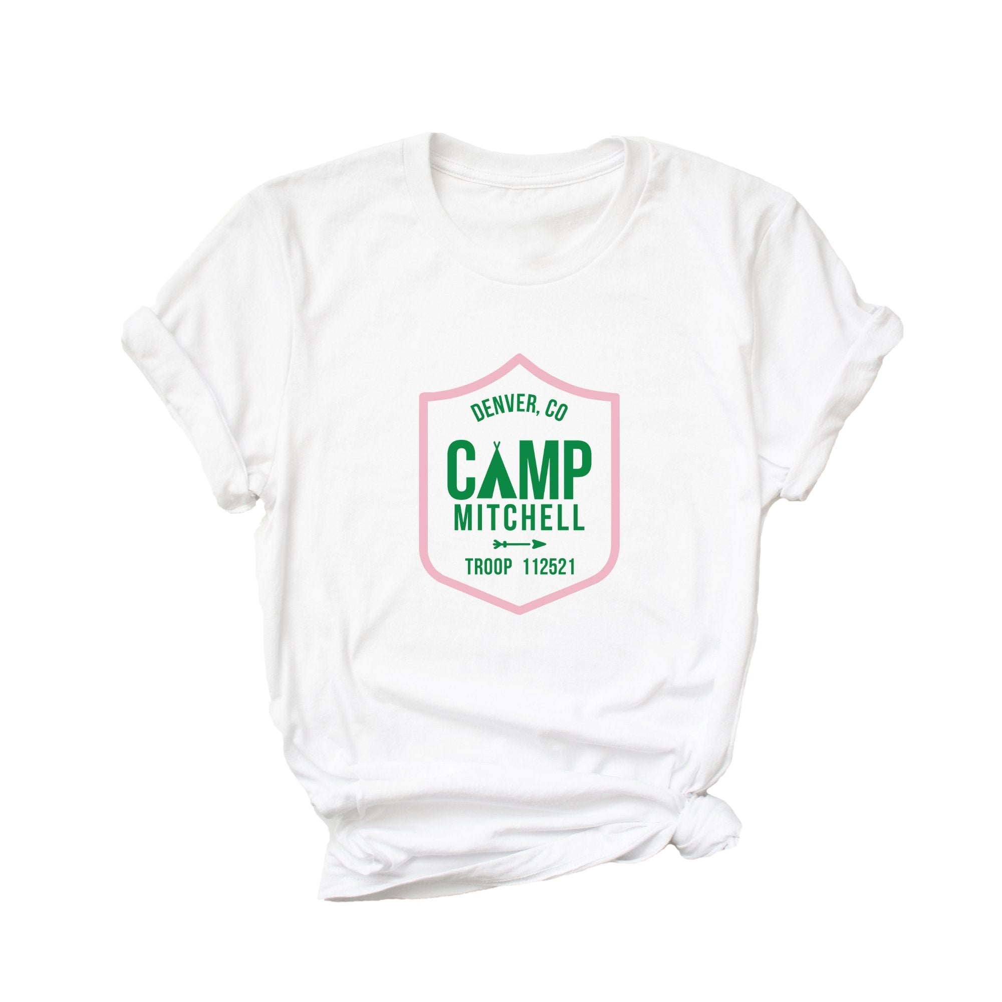 A white t shirt is customized with a green and pink camp logo