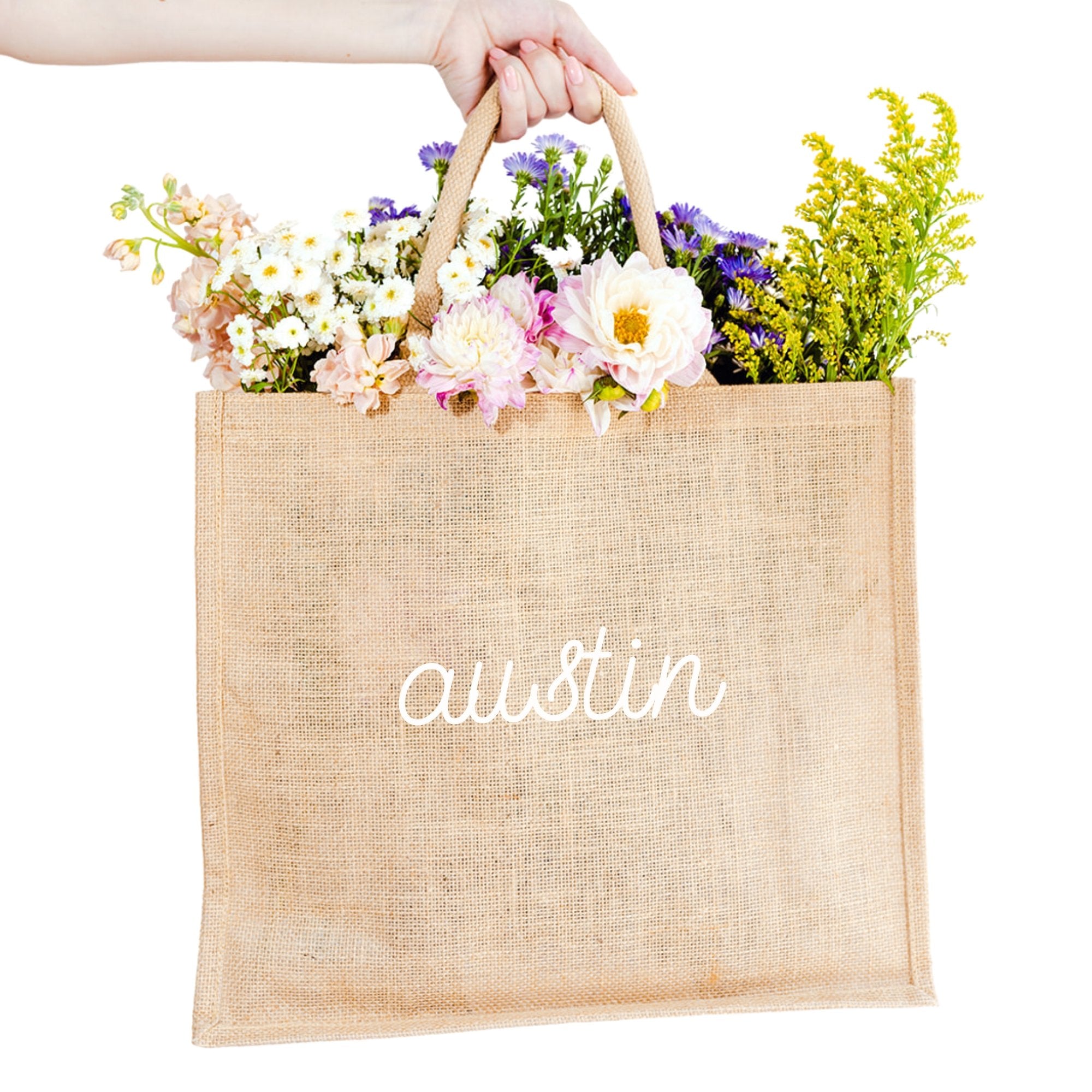 A custom jute bag reads "Austin" on the front in cursive