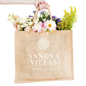 A jute carryall is personalized with a custom logo in white.