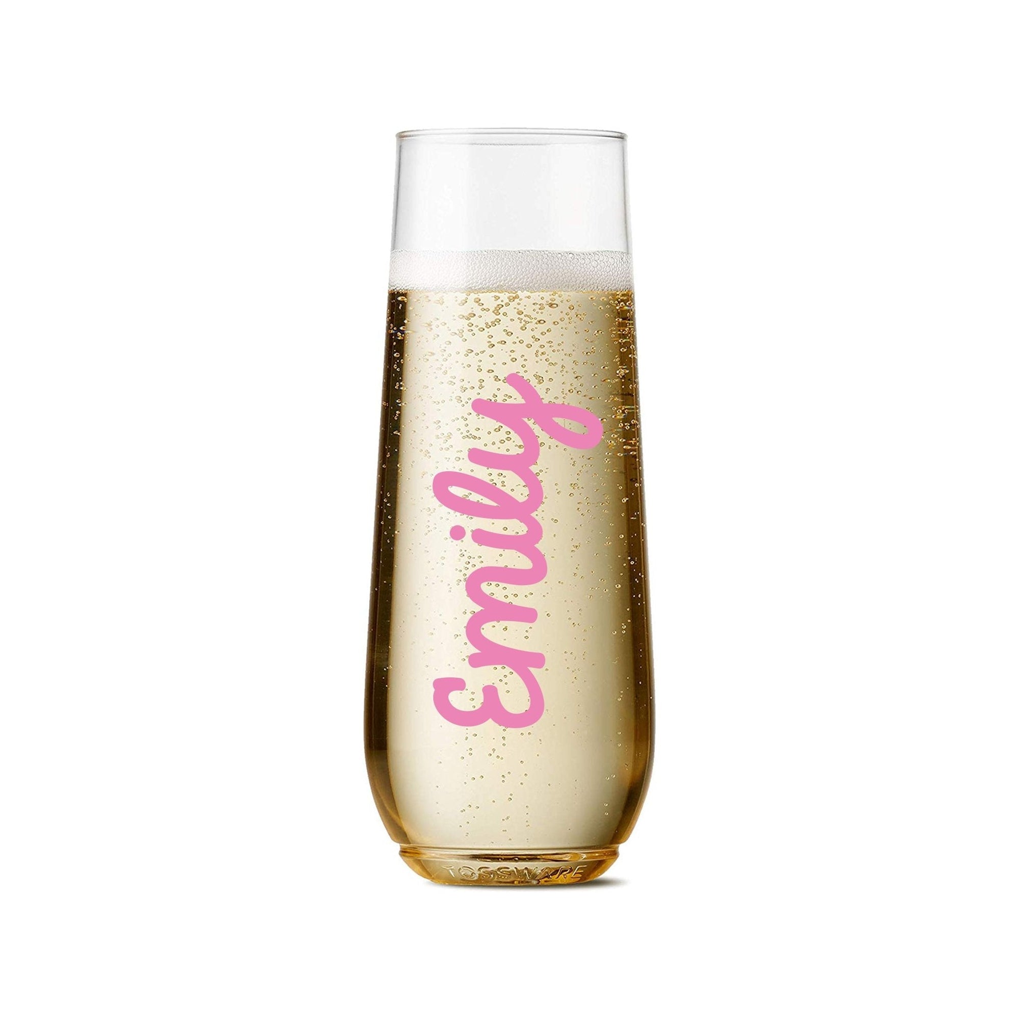 A champagne flute is customized with a name in a script gold font.
